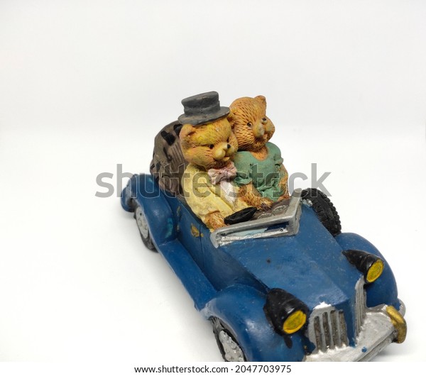 Bear couple in blue car
in miniature
