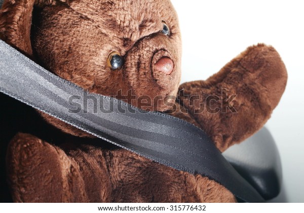 The\
bear doll in action of fall down the head to the car steering\
represent the car accident concept related idea.\

