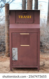 Bear proof trash container at park.  Vertical.