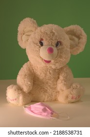 A Bear Toy With A Pink Medical Mask. Pink And Greeen Colors.Common Mask-wearing Mistakes. Education Image For Preschool Classroom.