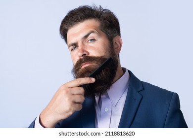 Beard care. Closeup of a young man styling his long beard with a comb. Bearded man with beard, bearded gay. Barbershop concept. - Shutterstock ID 2118813620