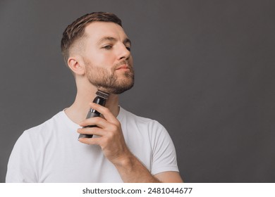 Beard hair trimmer, portrait or happy man with bathroom routine, grooming for shaving skincare. Face cleaning, facial growth maintenance or studio person happiness on gray background