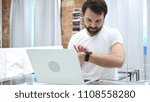 Beard Man Using Smartwatch for Browsing, Email and Messages