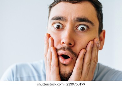 Beard man wonder, wearing casual t-shirt standing over isolated white background afraid and shocked with surprise expression, fear and excited face. Man looking at camera with surprised expression - Shutterstock ID 2139750199