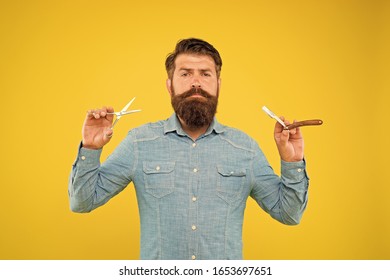 Beard And Mustache. Hipster With Long Beard And Mustache Hair Yellow Background. Bearded Man Holding Beard Grooming Tools. Beard Shaping And Styling In Barbershop.