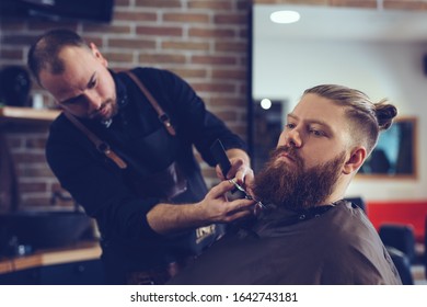 Beard styling and cut.Hipster client visiting barber shop. - Shutterstock ID 1642743181