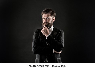 The beard trend will never truly be gone. Serious groom touch beard. Unshaven hipster with textured beard hair. Bearded man with stylish mustache and beard shape. Barbershop. Barbers salon.