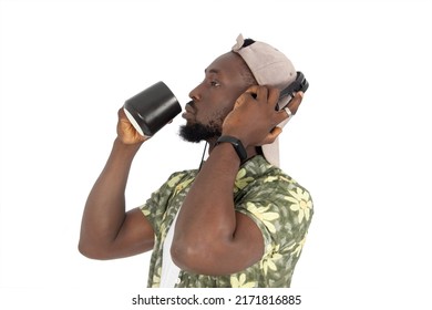 Bearded African Man With Cup In Hands Drinking Coffee, And Looking In Profile. Addicted To Coffee Or Tea. Coffee Flavor