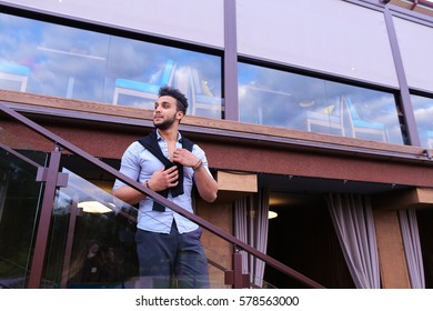 Bearded Arab Man, Businessman Students Gathered To Spend Time At Restaurant And Decided To Have Dinner, Arranged Business Meeting With Colleagues And Waits At Entrance To Restaurant, Smiling And