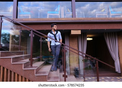 Bearded Arab Man, Businessman Students Gathered To Spend Time At Restaurant And Decided To Have Dinner, Arranged Business Meeting With Colleagues And Waits At Entrance To Restaurant, Smiling And