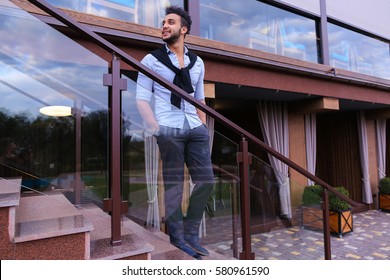 Bearded Arab Man, Businessman Students Gathered To Spend Time At Restaurant And Decided To Have Dinner, Arranged Business Meeting With Colleagues And Waits At Entrance To Restaurant, Smiling And