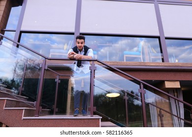 Bearded Arab Man, Businessman Students Gathered To Spend Time At Restaurant And Decided To Have Dinner, Arranged Business Meeting With Colleagues And Waits At Entrance To Restaurant, Smiling And