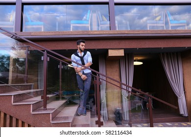 Bearded Arab Man, Businessman Students Gathered To Spend Time At Restaurant And Decided To Have Dinner, Arranged Business Meeting With Colleagues And Waits At Entrance To Restaurant, Smiling And