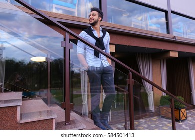 Bearded Arab Man, Businessman Students Gathered To Spend Time At Restaurant And Decided To Have Dinner, Arranged Business Meeting With Colleagues And Waits At Entrance To Restaurant, Smiling And