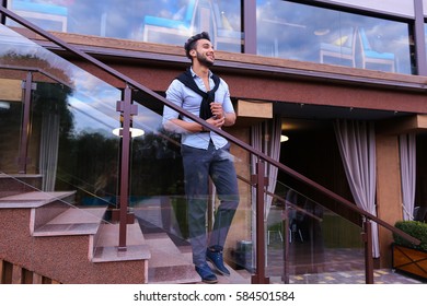 Bearded Arab Man, Businessman Students Gathered To Spend Time At Restaurant And Decided To Have Dinner, Arranged Business Meeting With Colleagues And Waits At Entrance To Restaurant, Smiling And