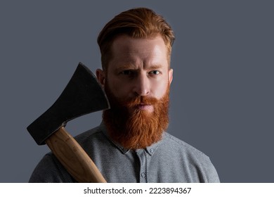 Bearded Barber Man With Sharp Axe Blade Has Red Beard. Studio Shot Of Bearded Barber Man.