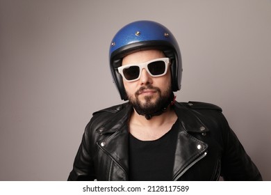 Bearded Biker Man Posing In Leather Jacket And Blue Motorcycle Helmet.