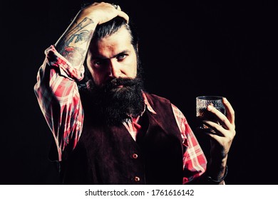 Bearded businessman in elegant suit with glass of whiskey. Sipping whiskey. Bearded handsome man holding glass of whiskey - Powered by Shutterstock