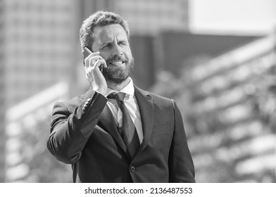 Bearded Businessperson In Formalwear Has Phone Conversation Outside The Office, Mobile Technology