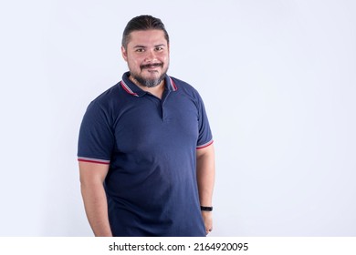 A bearded chubby man of mixed ancestry in his 30s. Wearing a blue polo shirt. Isolated on a white background.