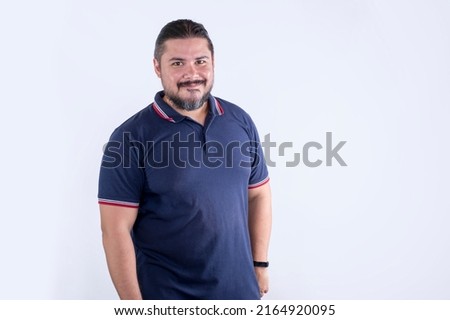 A bearded chubby man of mixed ancestry in his 30s. Wearing a blue polo shirt. Isolated on a white background.