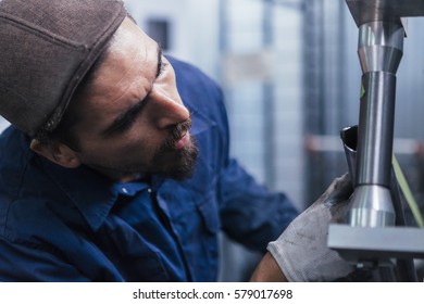 Bearded constructor working with metal bars