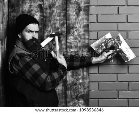 Similar – Image, Stock Photo bearded man huntsman with two axes stands near a rusty train