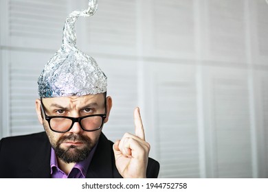 Bearded Funny Man In Cap Of Aluminum Foil. Concept Art Phobias. Conspiracy Theory. Conspiracy. Insanity.