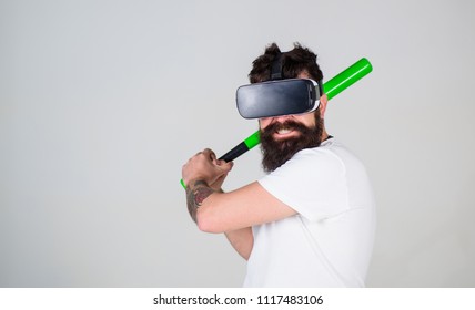 Bearded Gamer With Agitated Look Training Batting Skills, Simulation Game Concept. Man With Stylish Beard Posing With Baseball Bat Isolated On Gray Background. Bearded Man In VR Headset Doing Sports.