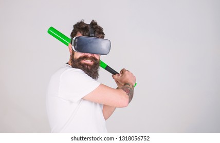 Bearded Gamer With Agitated Look Training Batting Skills, Simulation Game Concept. Man With Stylish Beard Posing With Baseball Bat Isolated On Gray Background. Bearded Man In VR Headset Doing Sports.