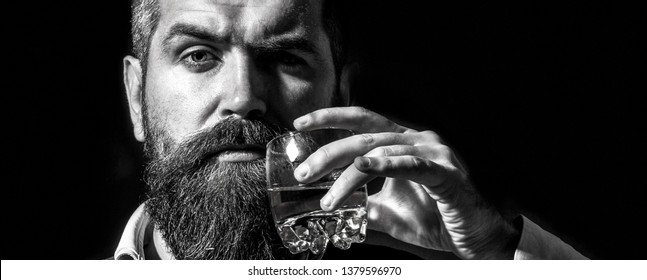 Bearded Gentleman Drink Cognac. Sipping Finest Whiskey. Portrait Of Man With Thick Beard. Macho Drinking. Stylish Rich Man Holding A Glass Of Old Whisky. Black And White.