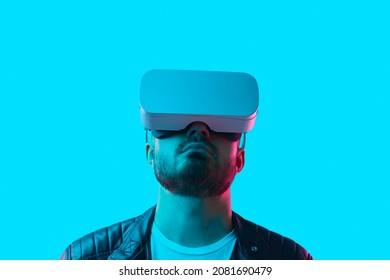 Bearded Guy In VR Headset Standing Under Blue Neon Illumination