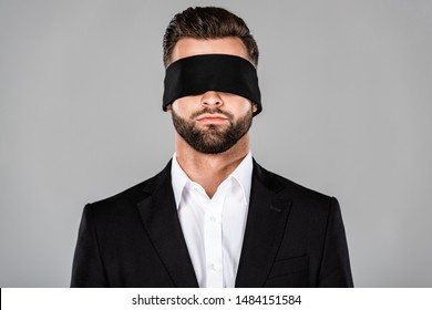 bearded handsome blindfolded businessman in black suit isolated on grey