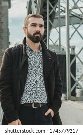 Bearded Handsome Caucasian Guy Staying And Seeing Someone On The Bridge On A Cloudy Day.