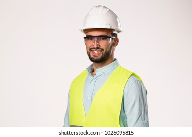 Bearded Handsome Smiling Engineer Worker L , Wearing Security Helmet Glasses And Vest , Isolated On White