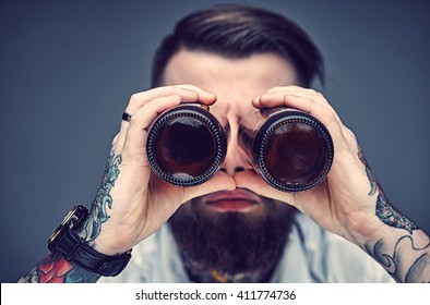 Bearded Hipster Man Holding Beer Bottles Like Binocular.