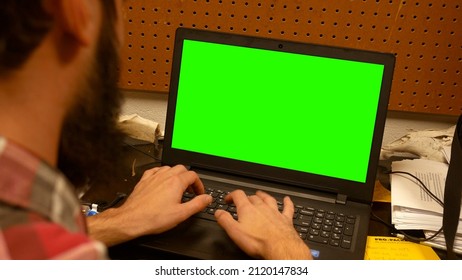 Bearded Hipster Millennial Male Types On Laptop In His Dorm Room At College