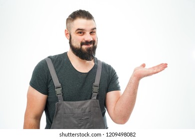 Bearded hipster young man wearing in t-shirt. Looking at his hand isolated on white background - Shutterstock ID 1209498082