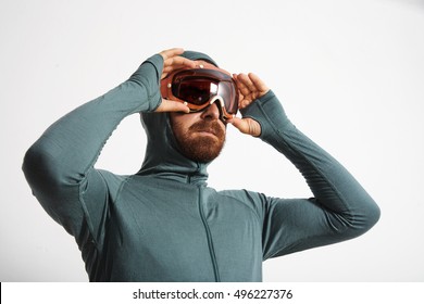 Bearded Male Athlete In Baselayer Thermal Suite Wears Snowboarding Googles