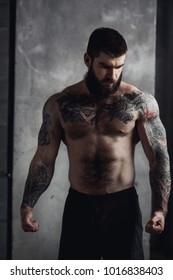 Bearded male bodybuilder in gym