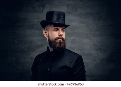 Bearded male with tattoo on his neck and top hat cylinder on head.