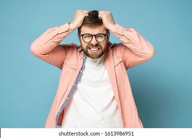 Bearded Man In Anger And Furious, He Is Trying To Tear Out His Hair On Head And Grins Teeth.