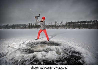 Bearded man with an ax chops ice at the lake - Powered by Shutterstock