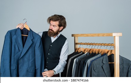 Bearded Man Collector Vintage Clothes Showing Formal Suit, Second Hand Store Concept.