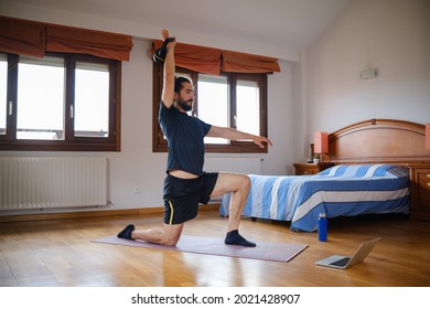 Bearded Man Doing Kettlebell Lunge At Home With An Online Exercise Class.