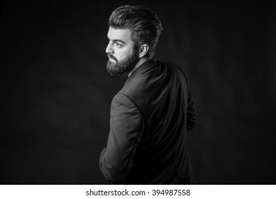 bearded man dressed in elegant suit, black and white