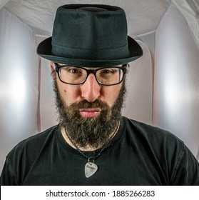 A Bearded Man With A Duck Face In A Sexy Mood With Black Glasses And Hat