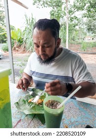 Bearded Man Eating Nasi Lemak At The Local Stall In The Morning.