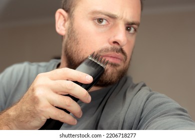 Bearded Man With Electric Razor