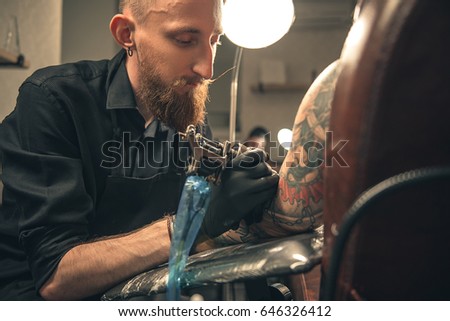 Bearded man expressing calmness. He creating image on hand in room